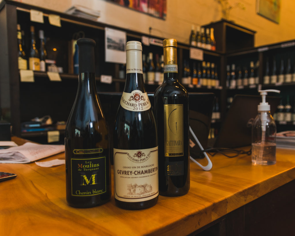 The recommended three bottles of wine sit atop the counter at Monopole Wine.