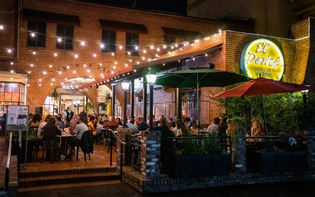 Evening shot of many tables occupied by happy guests at El Portal Restaurant