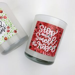 Candle with label that reads Stop and Smell the Roses