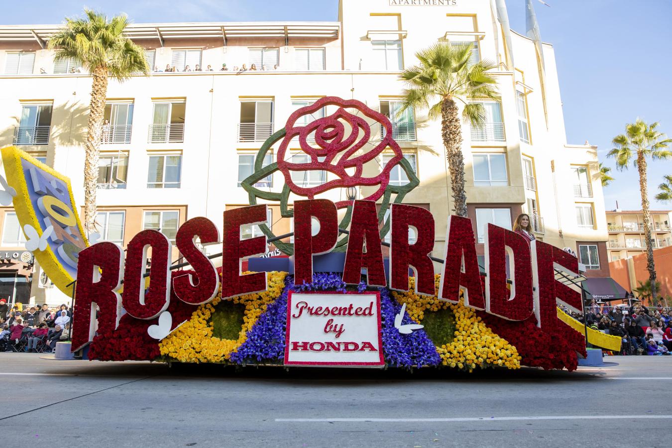 Floral-decorated Rose Parade float travels down Colorado Boulevard through Playhouse Village