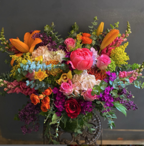 Colorful floral arrangement from Jacob Maarse set against a gray backdrop.