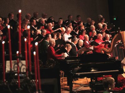 Candlelight & Carols choir singing among candles.