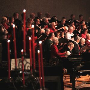 Candlelight & Carols choir singing among candles.