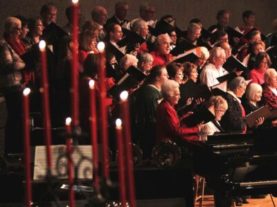 Candlelight & Carols choir singing among candles.