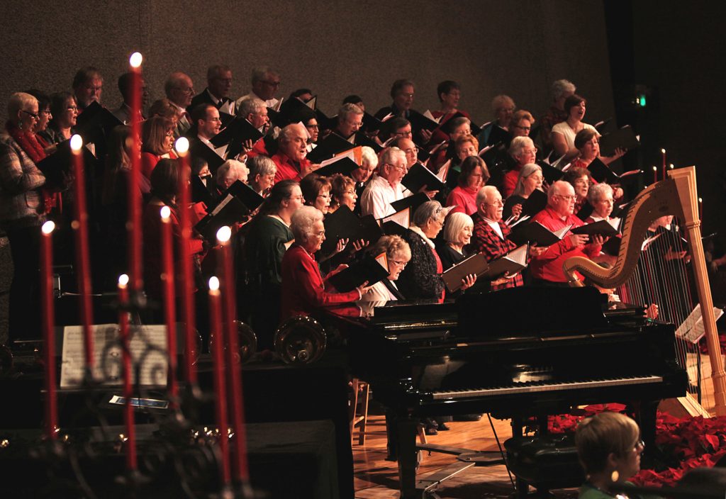 Candlelight & Carols choir singing among candles.