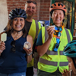 Biyclists enjoy ice cream in a cup and a paleta as they stop during the ice cream ride event for Bike Month.
