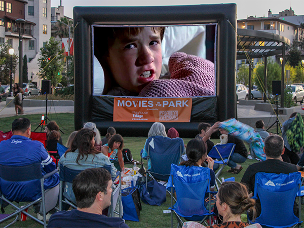 Family and friends gather to enjoy a film under the stars at Movies in the Park, presented by Playhouse Village Foundation and Landmark Theatres.