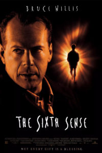 Movie poster for The Sixth Sense film features Bruce Willis with a dark shadow in the background.